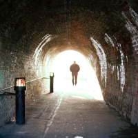 Man walking through tunnel